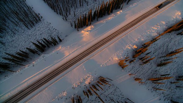 Silver Cybertruck in Snowy Sunset