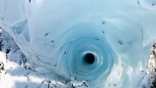 fpv racing drone fly-through in a glacial canyon